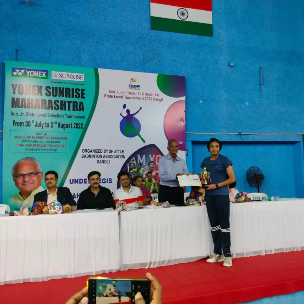 Nitesh Badminton Academy athlete receiving state selection tournament trophy at Sangli championship